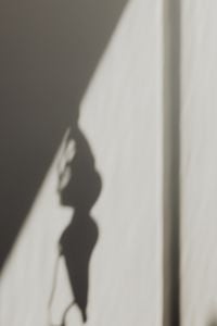 Kaboompics - Abstract Lace Lingerie Shadow on a White Curtain