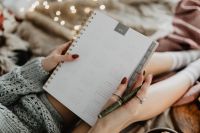 Kaboompics - Writing in a notebook lying in bed, with coffee, candles, and gingerbreads