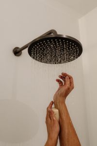 Kaboompics - Hands Reaching Toward a Round Shower Head