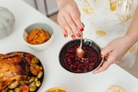 Kaboompics - Hands Stirring Homemade Cranberry Sauce in a Bowl for Thanksgiving Dinner, Holiday Food Preparation Close-Up
