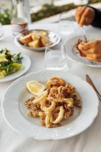 Kaboompics - Fried Calamari with Lemon, Bread and Table Setting
