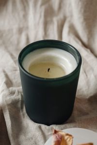 Kaboompics - Dark Candle Jar Styled With Incense Wood And Preserved Rose