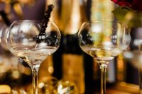Kaboompics - Two Champagne Flutes with Gold Party Lights and Red Roses in the Background