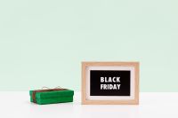 Kaboompics - Black Friday Sign and Green Gift Box on Mint Green Background