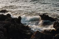 Kaboompics - Wave Crash Against a Black Rocky Shore