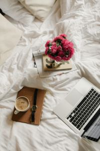 Kaboompics - Morning Work From Bed Flat Lay with Laptop, Coffee and Pink Flowers
