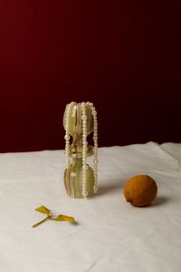 Kaboompics - Pearl Necklace Draped over Ornate Glassware on Linen