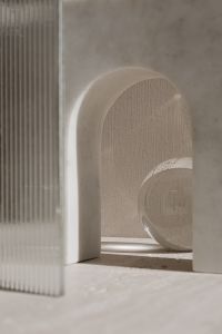 Kaboompics - Ribbed Glass Panel Framing an Arched Niche and Glass Sphere