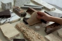 Kaboompics - Hands Styling White Marble Samples on a Creative Table
