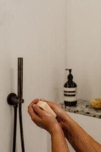 Kaboompics - Soapy Hands Under the Shower with Body Wash Nearby
