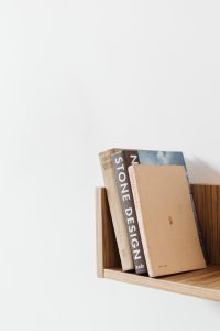 Kaboompics - Vertical Bookshelf Styling with Neutral Design Books on Oak Shelf