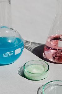 Kaboompics - Blue and Pink Laboratory Flasks on White Surface