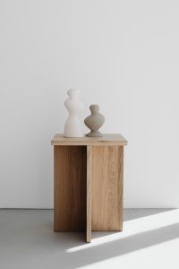 Kaboompics - Minimalist Oak Side Table with Two Ceramic Vases and Negative Space