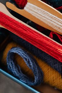 Kaboompics - Red Yarn Wound on a Wooden Weaving Shuttle