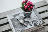 Kaboompics - Little pink flowers on a stack of magazines