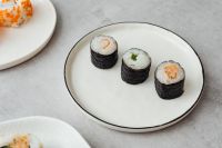 Kaboompics - Three Nori-Wrapped Sushi Rolls on a Minimal White Plate