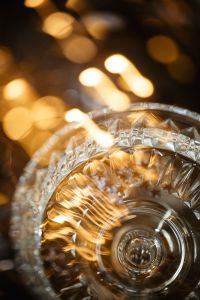Kaboompics - Champagne Coupe with Golden Reflections and Star Confetti