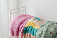 Kaboompics - Folded Pastel Sweaters on a White Rack