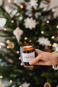 Kaboompics - Amber Candle Jar with White Christmas Ornaments