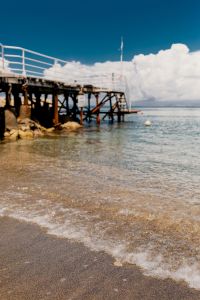 Kaboompics - Low-Angle Pier and White Railings against Bright Clouds and Blue Water