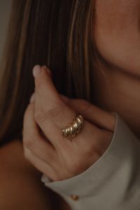 Kaboompics - Woman Wearing Gold Ring and Tan Silk Shirt Close-Up