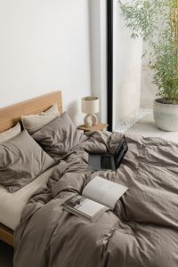 Kaboompics - Open Books and Laptop on a Cozy Gray Bed