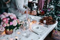 Kaboompics - Hands Placing a Wine Glass on a Festive Table Setting