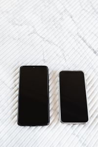 Kaboompics - Two Black-Screen Smartphones in a Vertical Flat Lay on White Marble