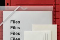 Kaboompics - Close Up of Red File Folder with Layered Invitation Stationery