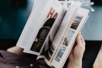 Kaboompics - Person Holding an Open Magazine in Close-Up