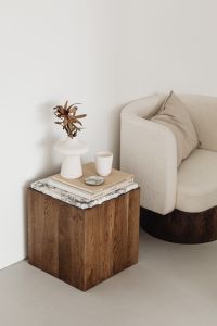 Kaboompics - Minimalist Living Room Corner with Walnut Pedestal, Sculptural Vase, Books and Armchair