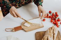 Kaboompics - Cutting Cheese on a Wooden Board