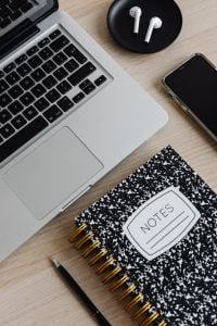 Kaboompics - Laptop, AirPods, Smartphone and Notes Notebook on Desk