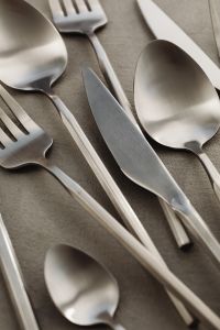 Kaboompics - Matte Stainless Steel Cutlery Close-Up on Textured Gray Tabletop