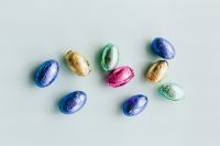 Kaboompics - Sparse Foil-Wrapped Easter Eggs Spread Across a White Surface