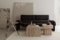 Kaboompics - Black Leather Sofa with Travertine Tables and Black Bowl