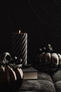 Kaboompics - Black Candle and Pumpkins on Dark Sofa