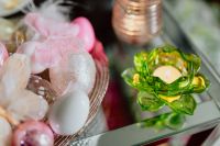 Kaboompics - Pastel Easter Eggs in Clear Glass with a Green Decorative Candle Holder and Pink Accents