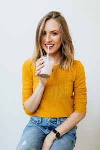 Kaboompics - Woman Drinking a Milkshake in a Mustard Yellow Sweater