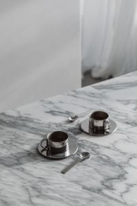 Kaboompics - Two Chrome Coffee Cups on Arabescato Marble Table