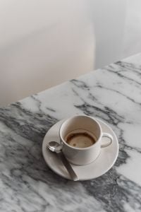 Kaboompics - White Coffee Cup and Spoon on Arabescato Marble
