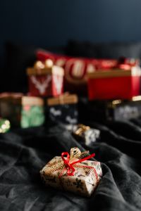 Kaboompics - Christmas Gifts Arranged on Textured Dark Bedding