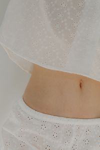 Kaboompics - White Pajamas Close-Up with Woman's Midriff