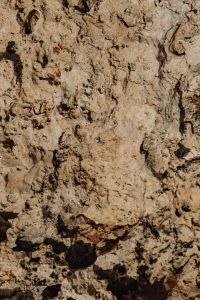 Kaboompics - Sunlit Pale Rock Texture with Rough Broken Edges