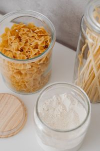 Kaboompics - Angled Close-Up of Bow-Tie Pasta and Spaghetti in Glass Pantry Jars