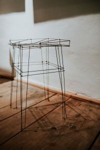 Kaboompics - Minimalist Wire-Frame Chair Display Against a White Exhibition Wall