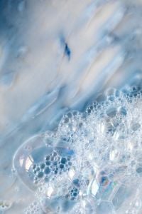 Kaboompics - Blue and White Skincare Cream Texture with Soft Diagonal Streaks and Foamy Edge