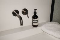 Kaboompics - Black Pump Bottle on White Towel Beside Shower Glass