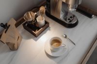 Kaboompics - Overhead Espresso Cup with Coffee Tools and Paper Coffee Bag