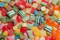 Kaboompics - Colorful Sugar-Coated Gummy Candy Mix with Striped Sweets and Jelly Pieces